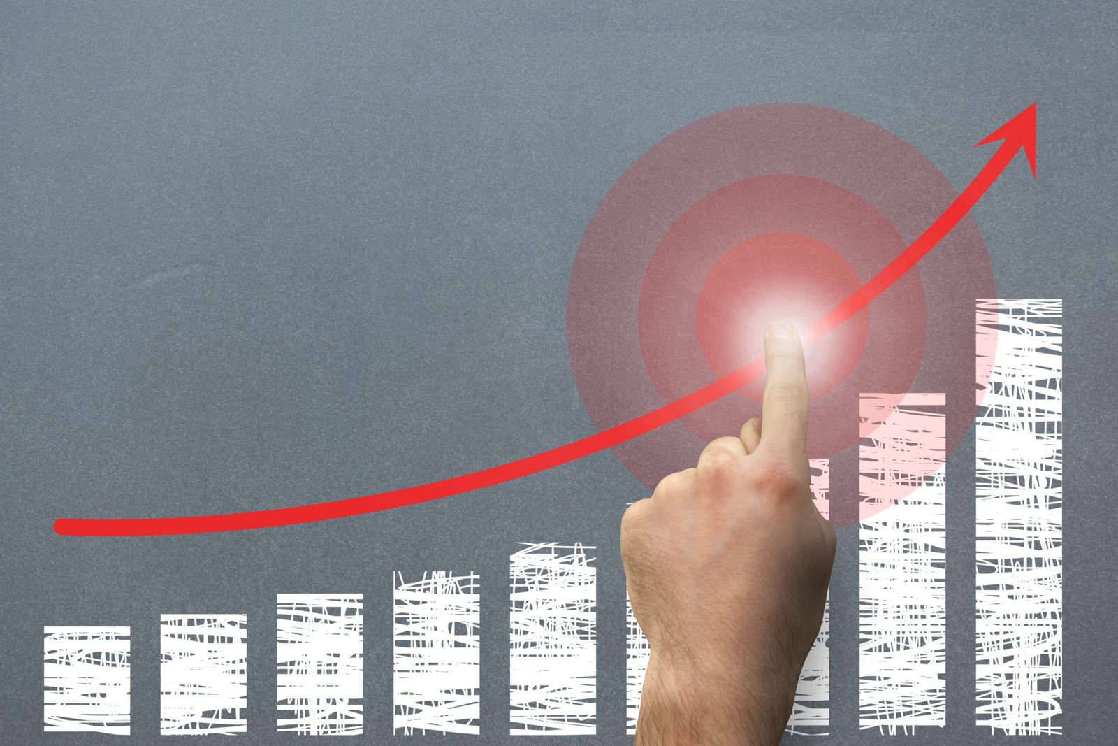 composite of hand pointing at rising graph